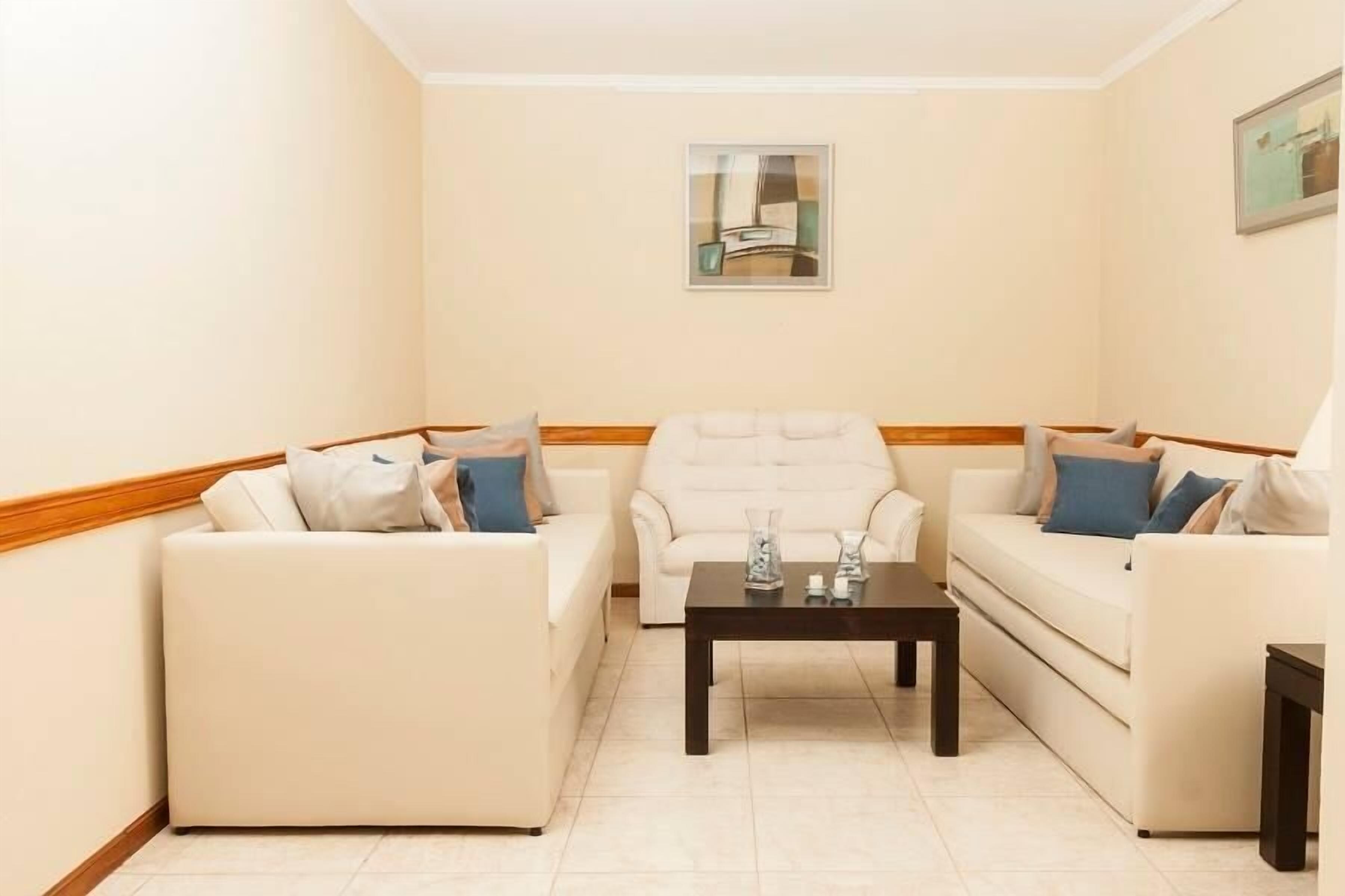 A living room with two sofas, a coffee table, and a framed picture on the wall.