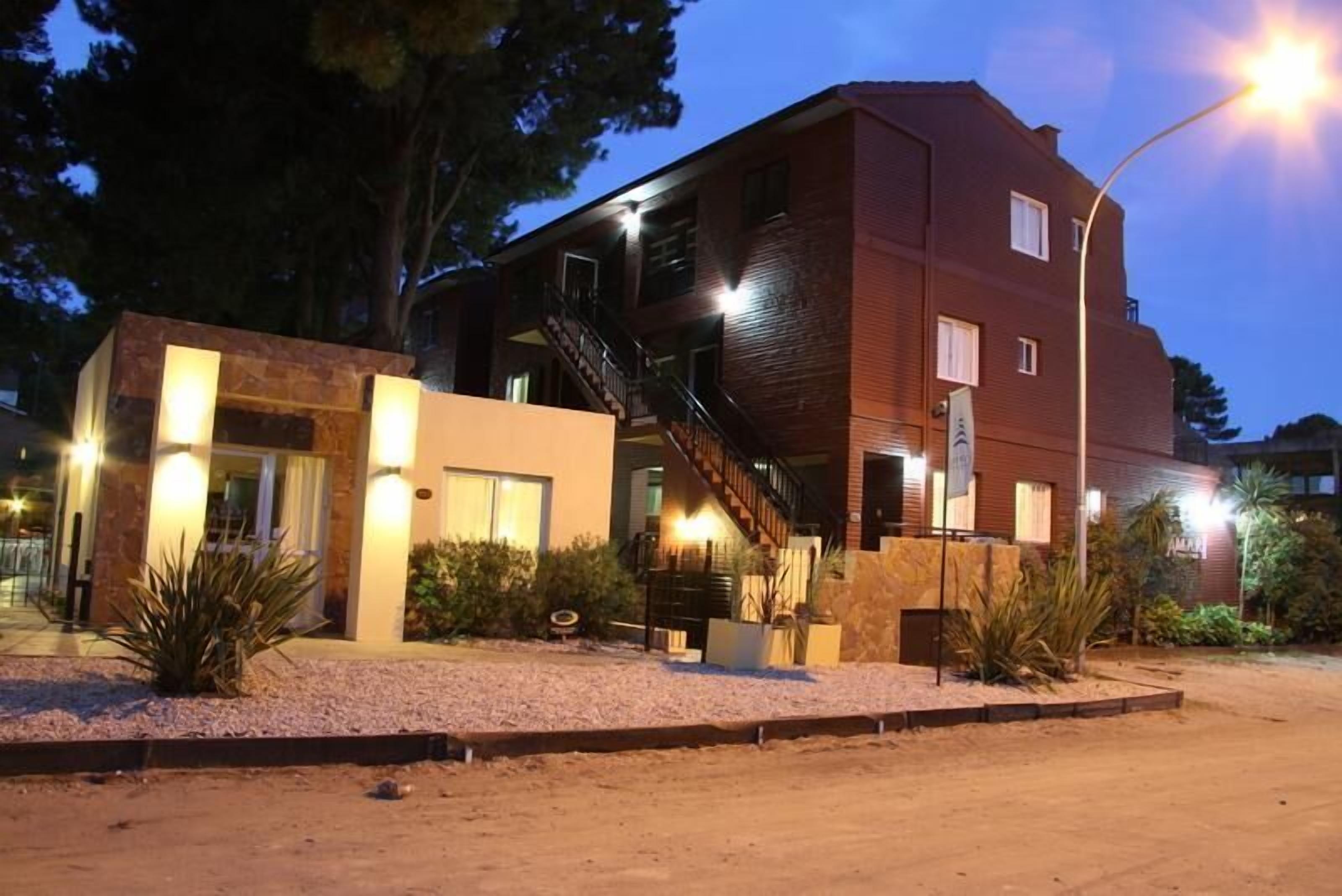 A two-story building with a modern design, featuring a staircase leading to the upper floor.