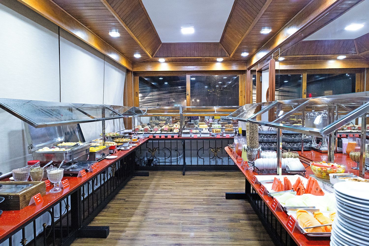 Un buffet con diverse postazioni gastronomiche e un'area di servizio centrale.