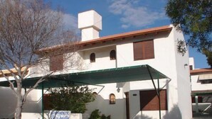 A white building with a green awning, a sign reading "DORMIENTOS Punta Tulum", and a date stamp of "16 18 2008".