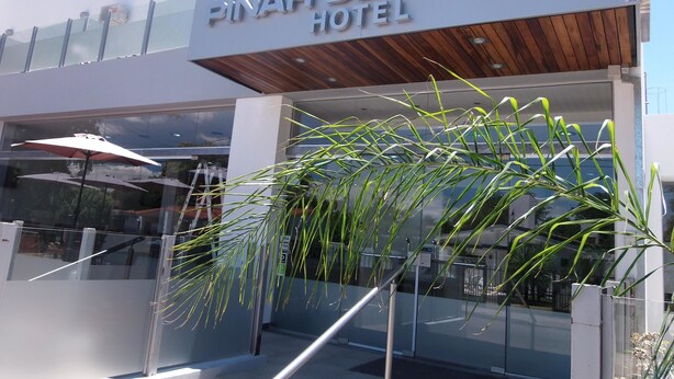 The exterior of the Pinar Del Lago Hotel with a modern design, featuring a prominent sign and a glass entrance. - Pinar del Lago (Villa Carlos Paz)