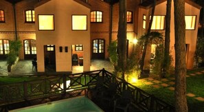 A hotel with a courtyard, outdoor seating, and a pool. - Las Hadas Carilo (Carilo)