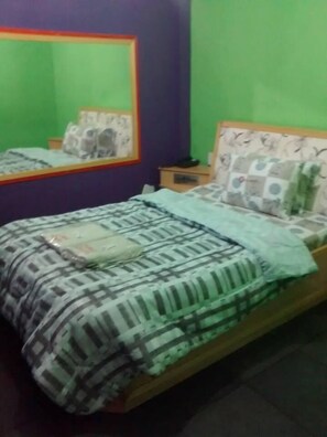 A room with a bed, a nightstand, and a mirror. - Hotel Dueto (São Bernardo do Campo)