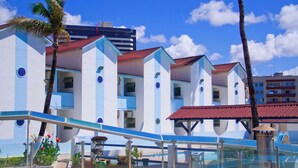 A hotel with a modern design, featuring multiple blue and white buildings with balconies.