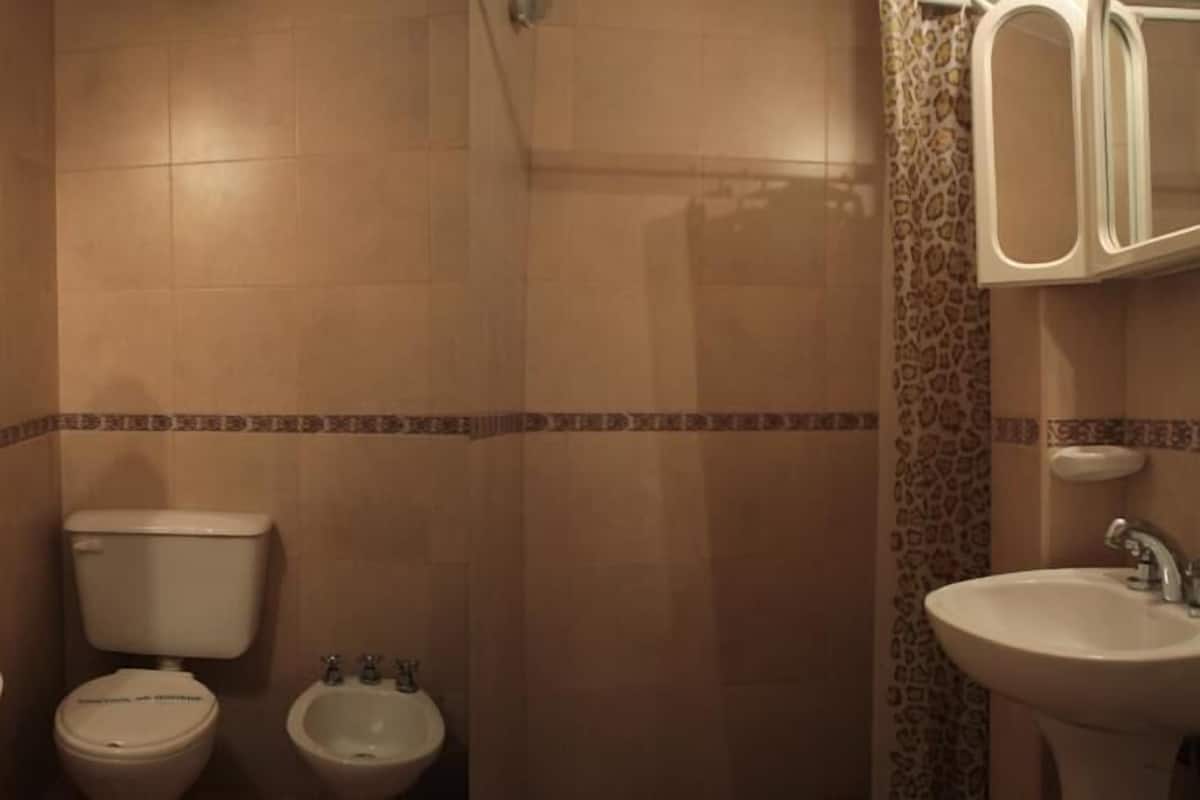 A bathroom with two sinks, a toilet, and a bidet.