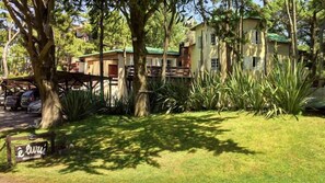 Escape to a serene oasis surrounded by lush tropical plants and a beautifully maintained lawn.