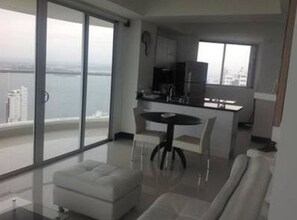 Un appartement moderne doté d’un balcon, d’un coin repas et d’une cuisine.