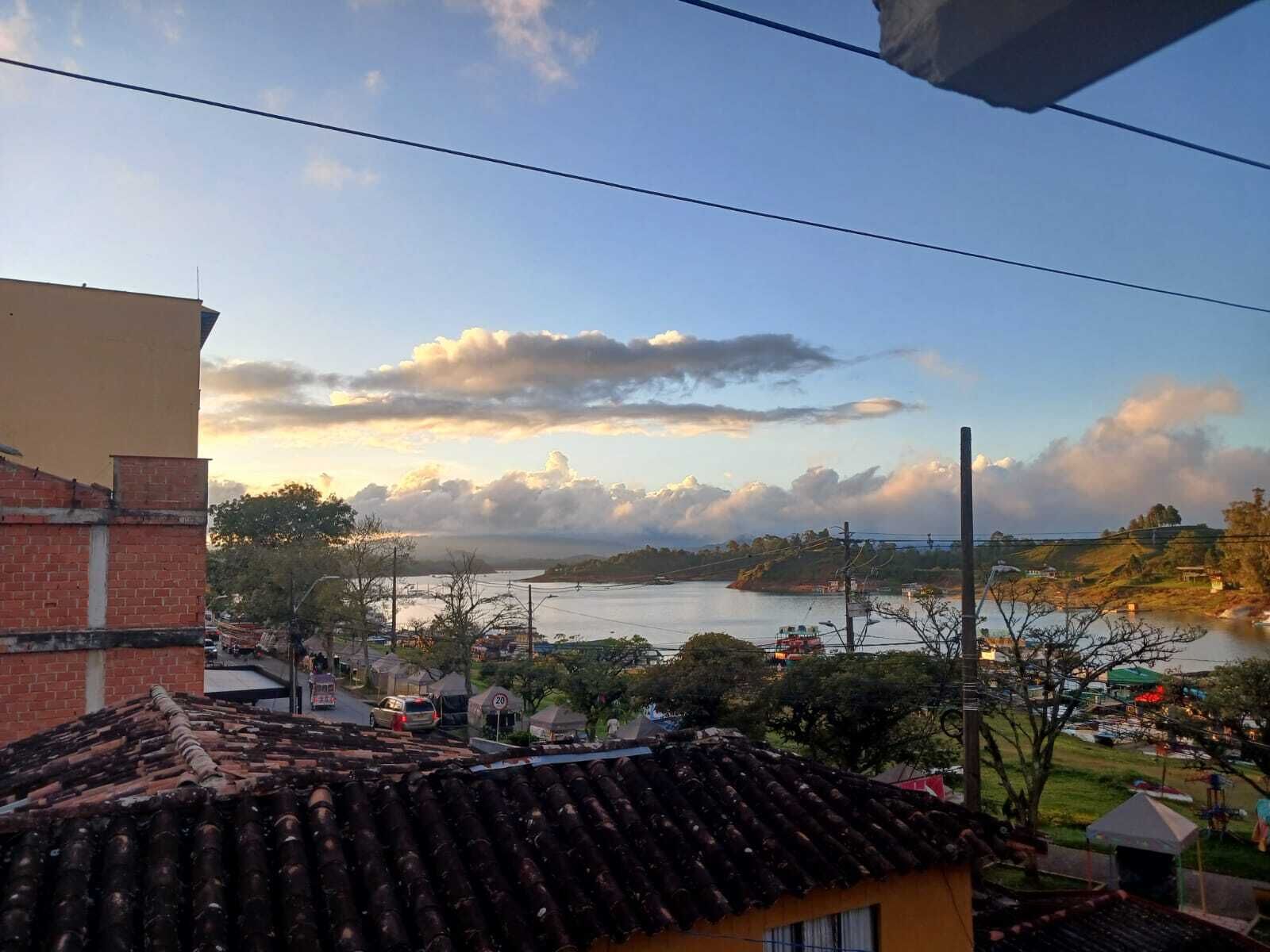 A residential area with a river, a bridge, and a clear sky.