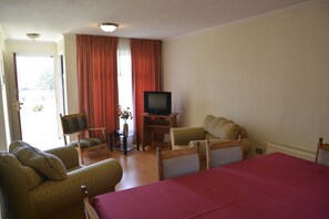 Standard Cabin, 3 Bedrooms | Living area | Flat-screen TV
