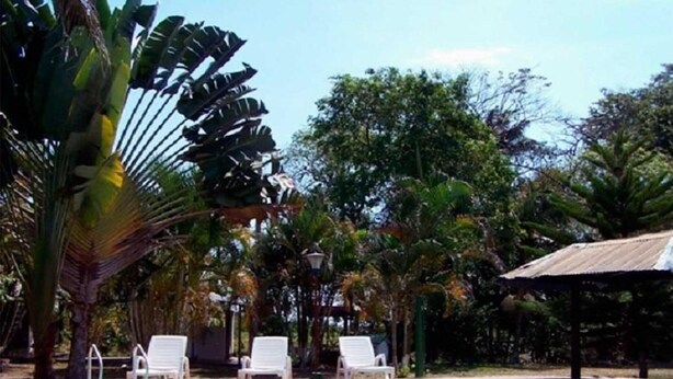 A pool area with lounge chairs and a gazebo. - Finca 028 (Restrepo)