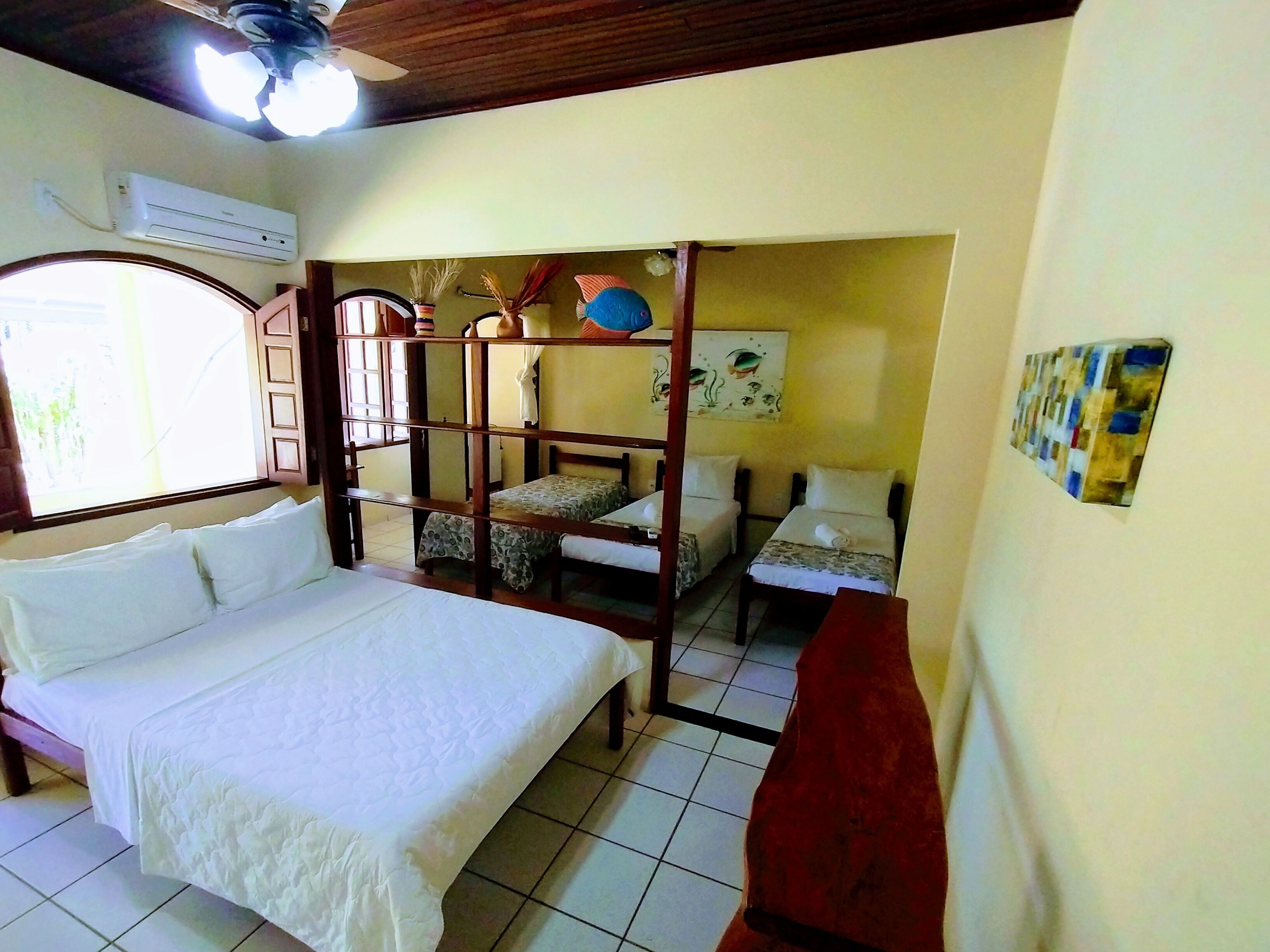 A room with a bed, a desk, and a bunk bed.