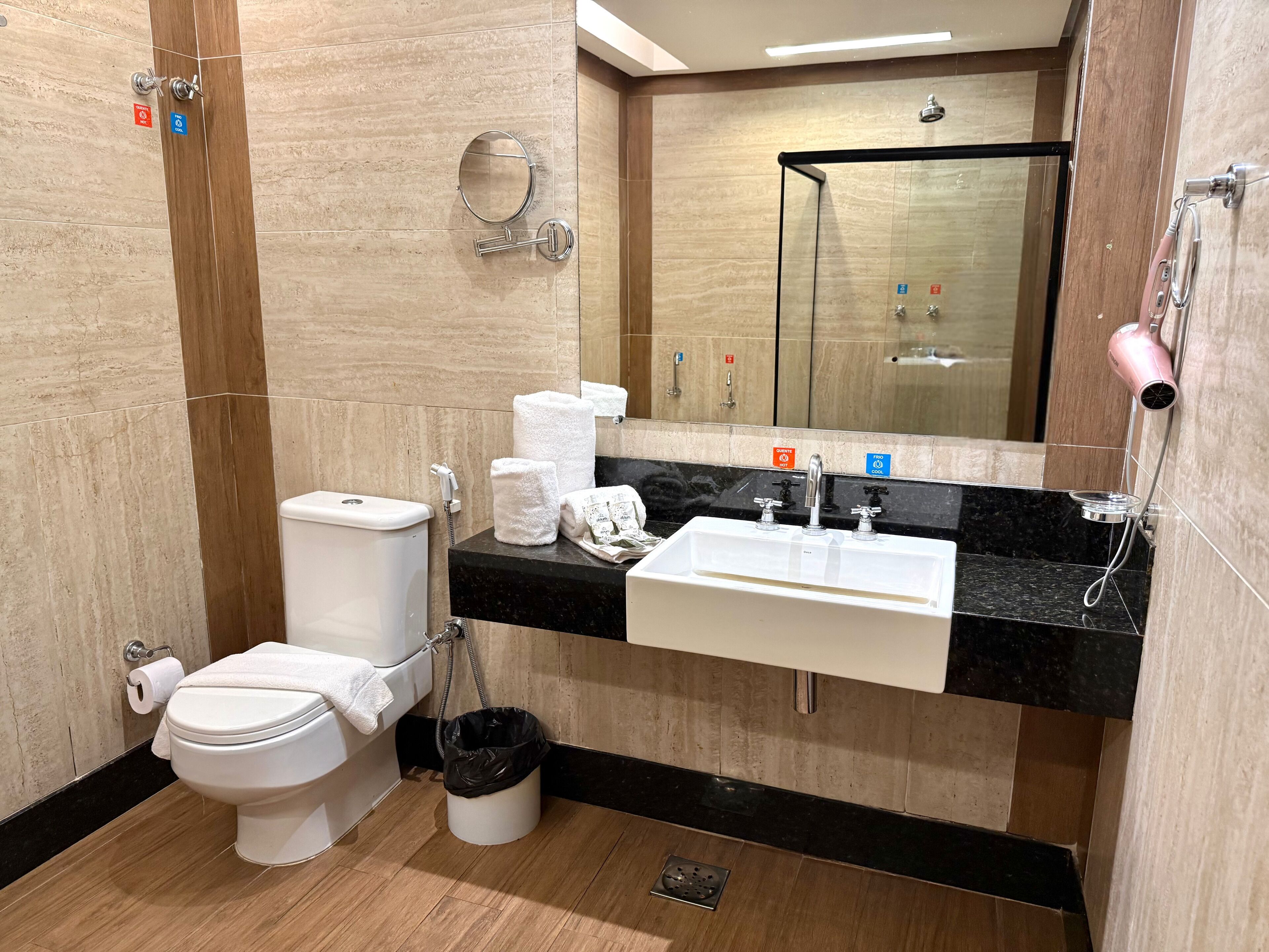 A modern bathroom with a toilet, sink, and shower.