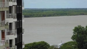 A multi-story building with balconies overlooking a river. - Catamarca Suites Land (Rosario)