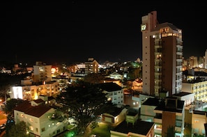 A multi-story hotel with a prominent clock tower, surrounded by other buildings. - Hotel Bahia (Villa Gesell)