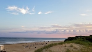 A beach with a lifeguard tower, sandy dunes, and the ocean. - Jaina Resort & Spa (Mar de Las Pampas)