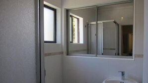 Ein Badezimmer mit Toilette, Waschbecken und Spiegel.