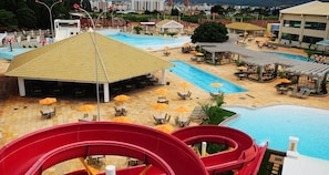 A water park with a large pool, slides, and outdoor seating areas. - Lacqua Di Roma I Via Caldas (Caldas Novas)
