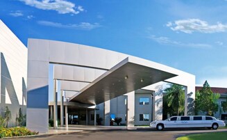 A modern building with a flat roof and large windows.