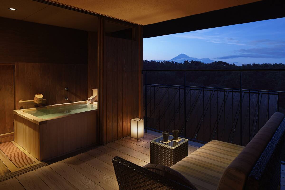 Ein modernes Badezimmer mit einer Holzwanne und einer Duschkabine aus Glas.