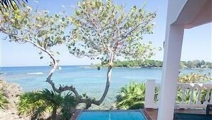 A rectangular swimming pool with clear blue water, surrounded by a tiled deck and a white structure. - Coral Vista 4 3 bedroom option (Roatan)