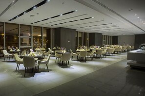 A modern dining area with tables and chairs arranged for guests.