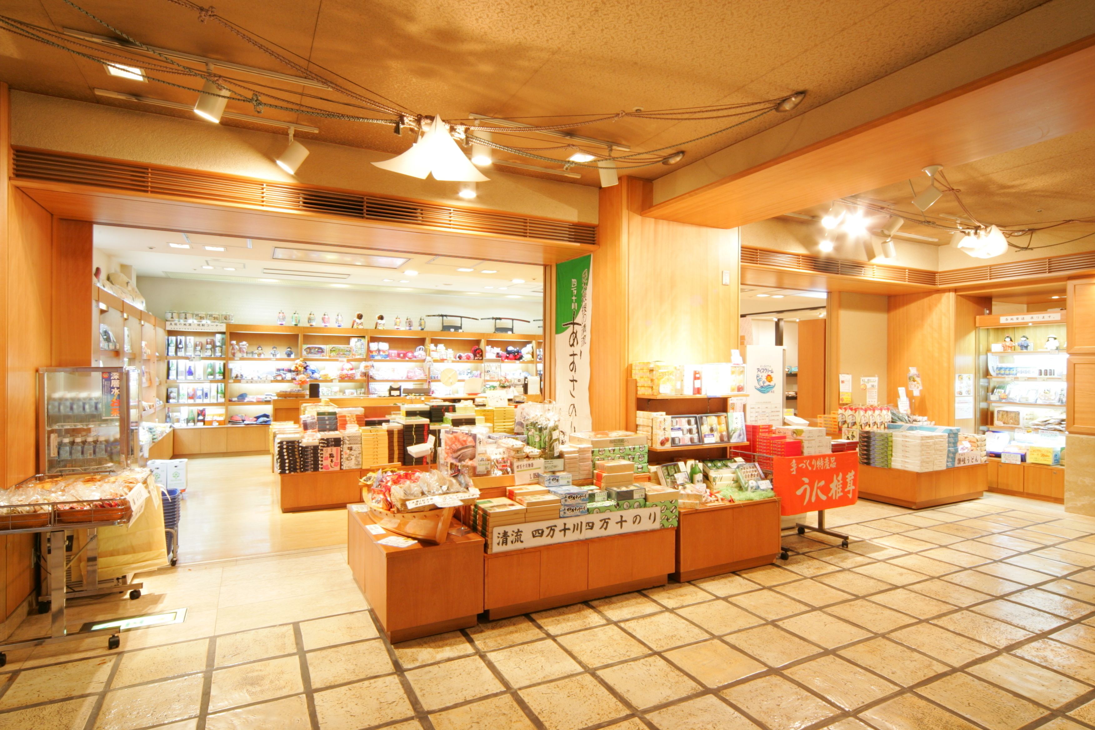 A spacious store with wide aisles and multiple shelves stocked with various products.