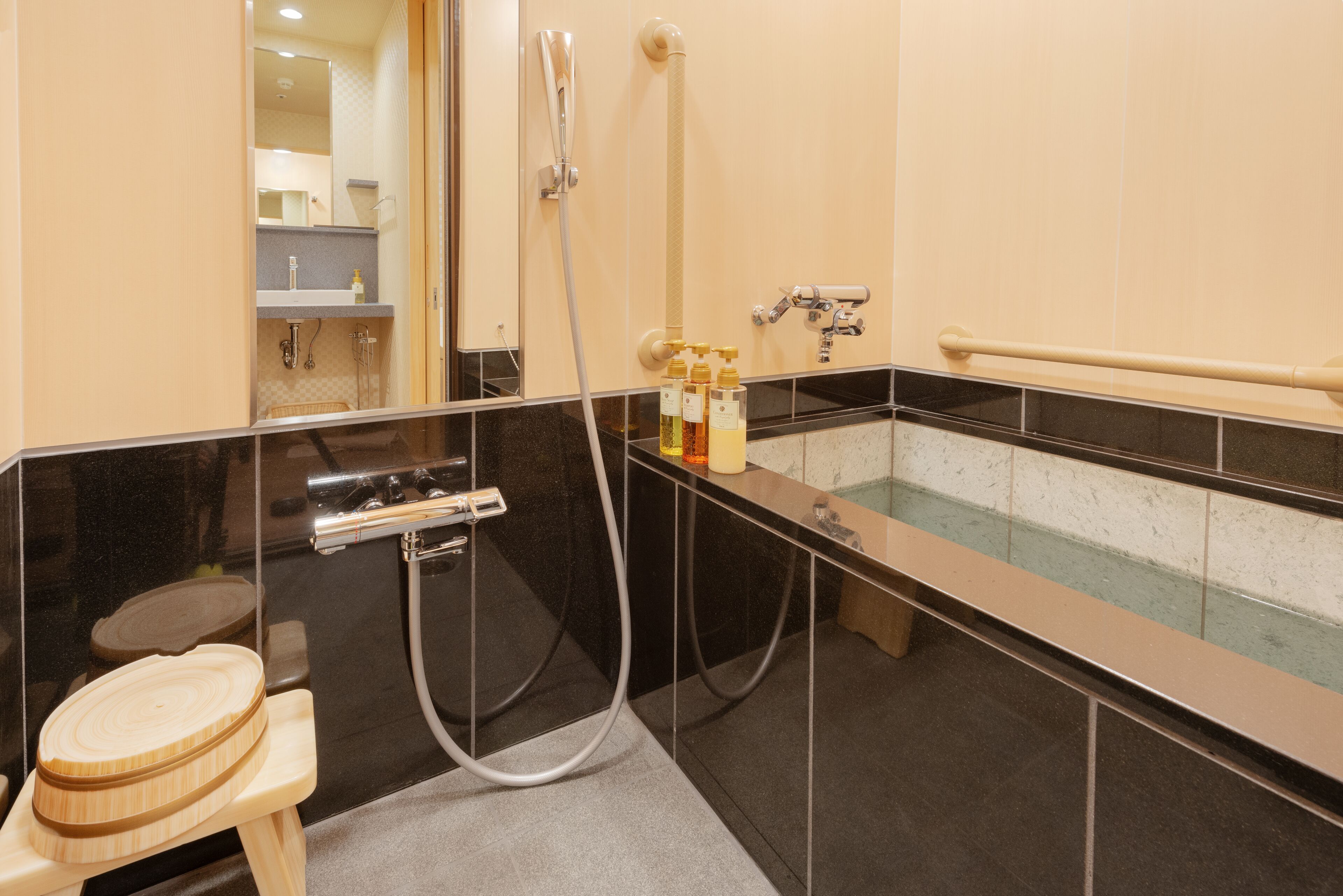 A modern bathroom with a bathtub, a shower, and a toilet.