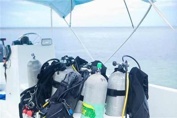 A boat with two oxygen tanks and a diving suit.