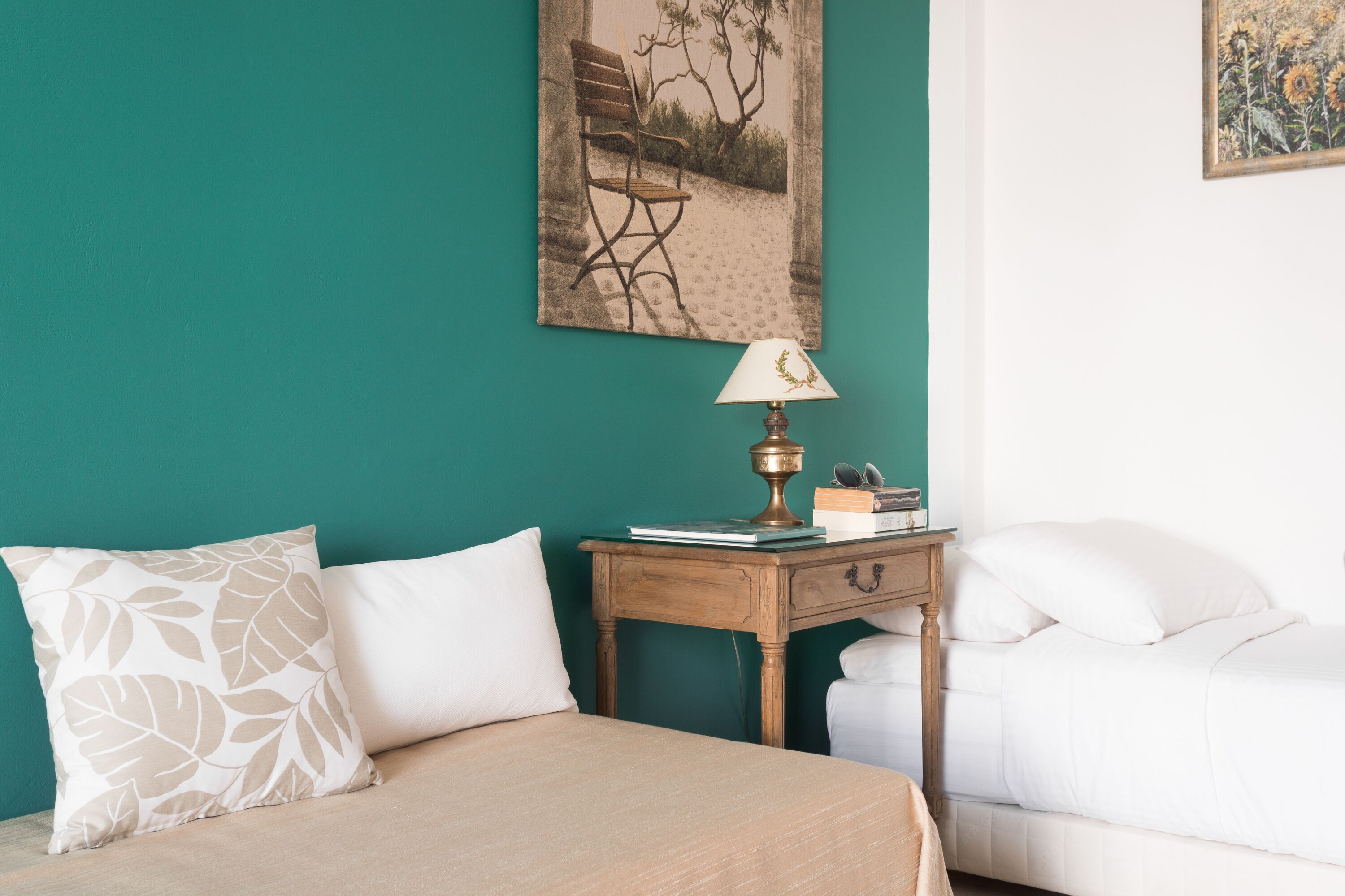 A bedroom with a bed, a nightstand, and a lamp.