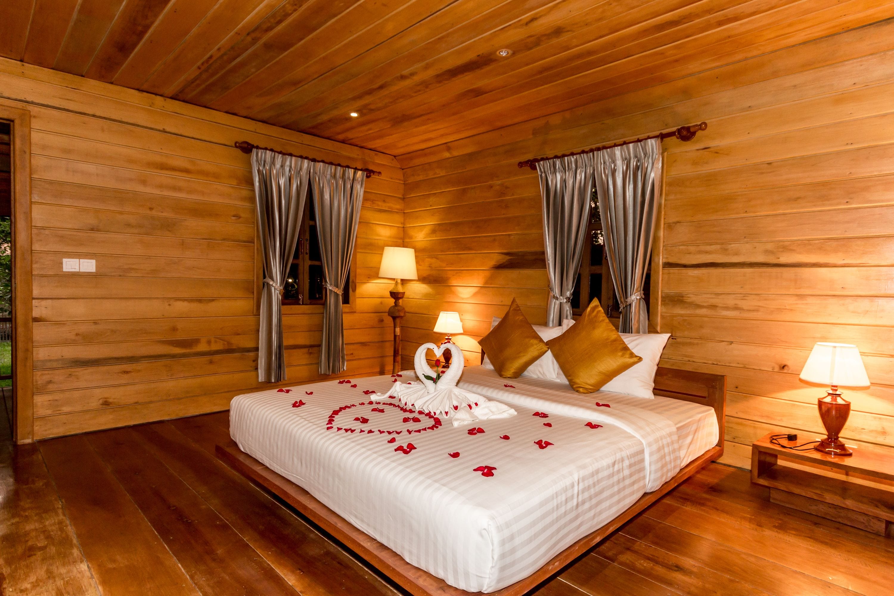 honeymoon cabin, 1 king bed, balcony, pool view | minibar, in-room safe, desk, laptop workspace