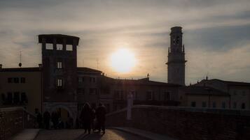 A historical building with a tower and a sunlit sky.