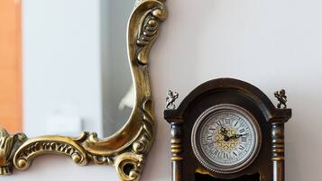 A wooden dresser with a clock and a mirror.