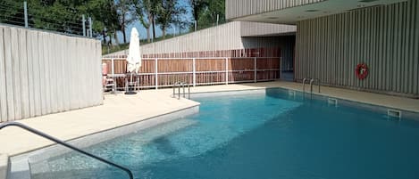 Seasonal outdoor pool, pool loungers