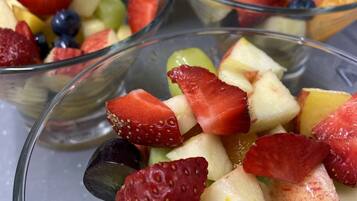 A close-up of fruit salad in clear glass bowls.