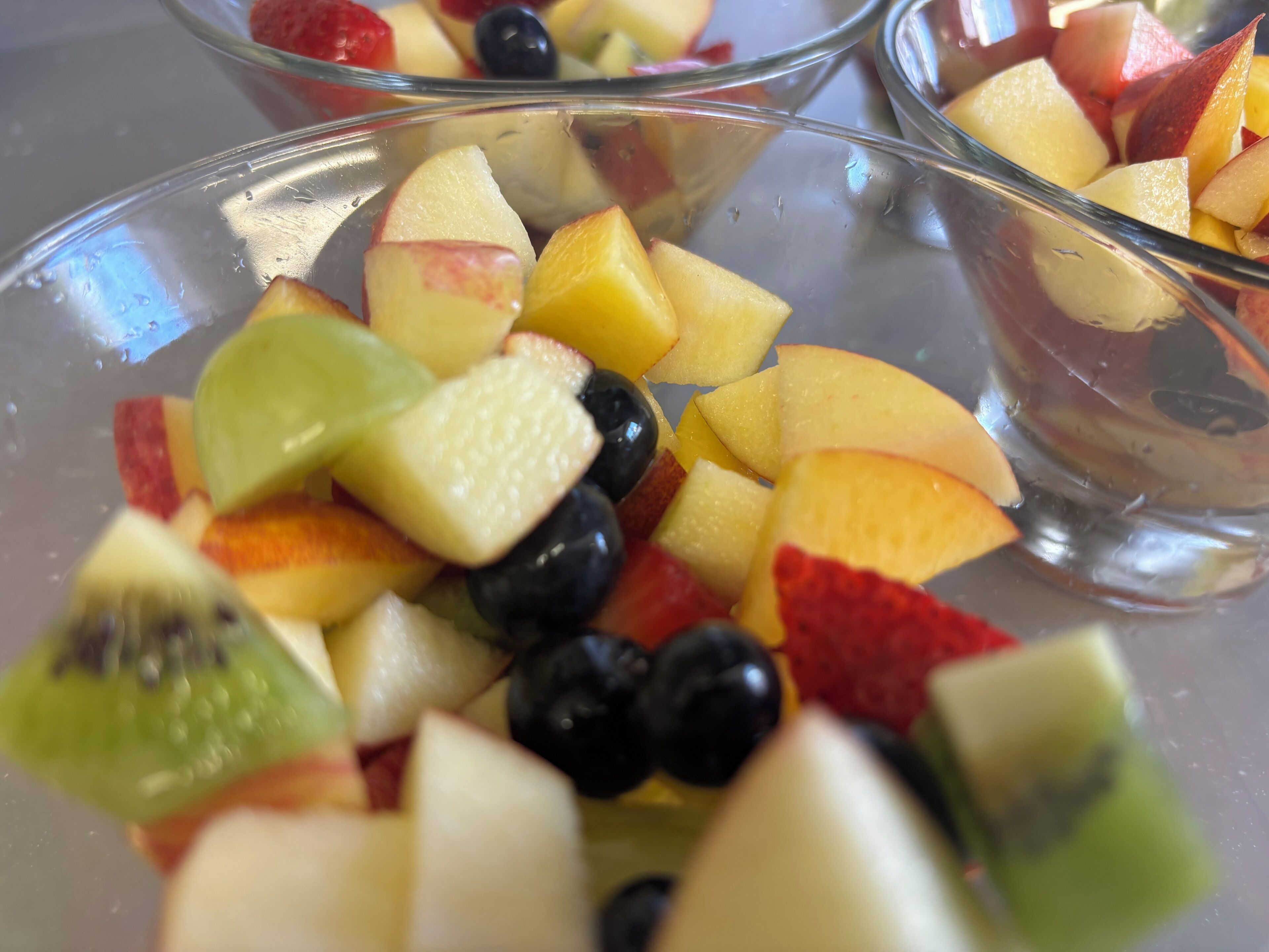A close-up of a fruit salad with various fruits.