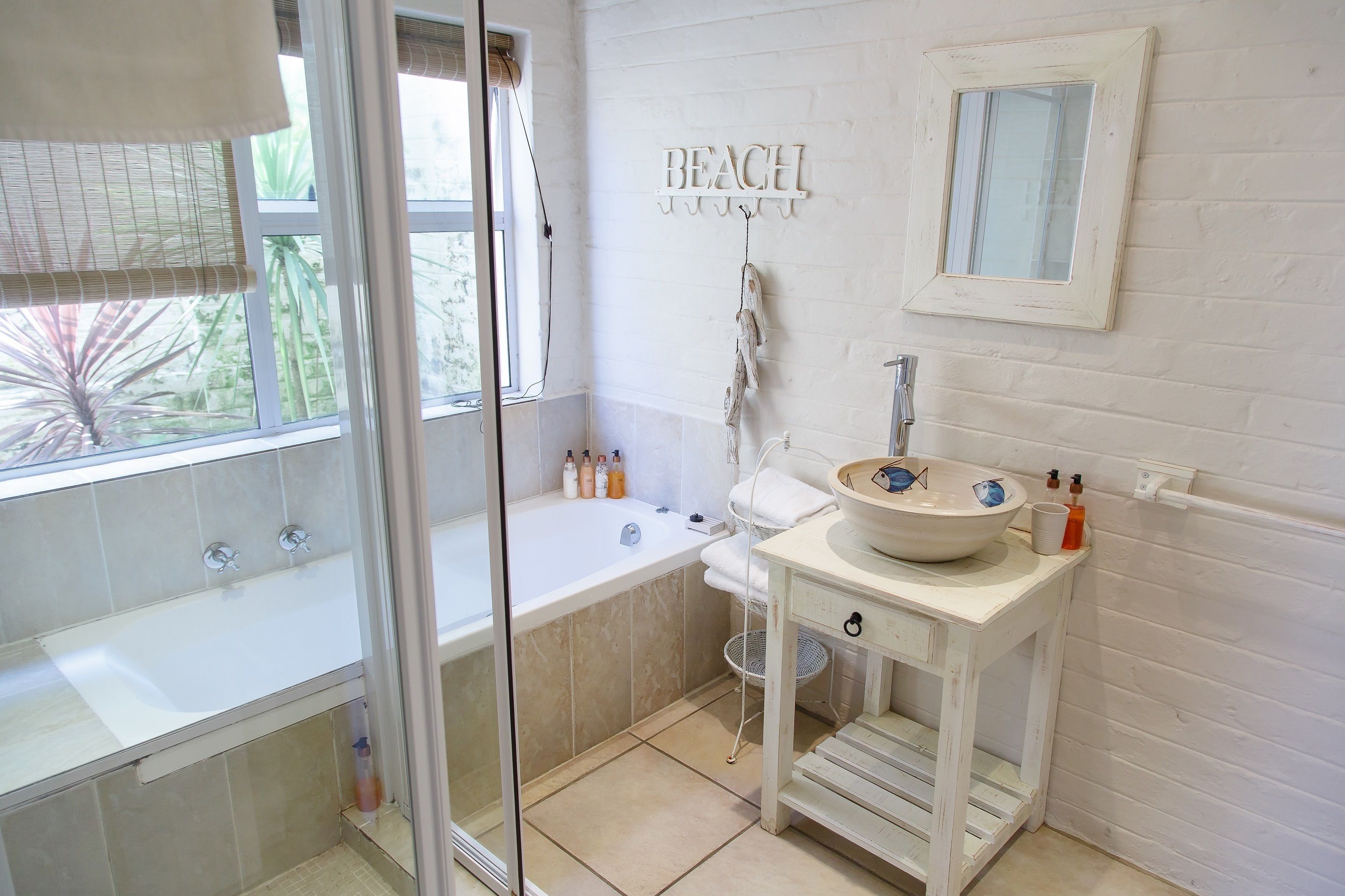 A bathroom with a bathtub, a sink, and a shower.
