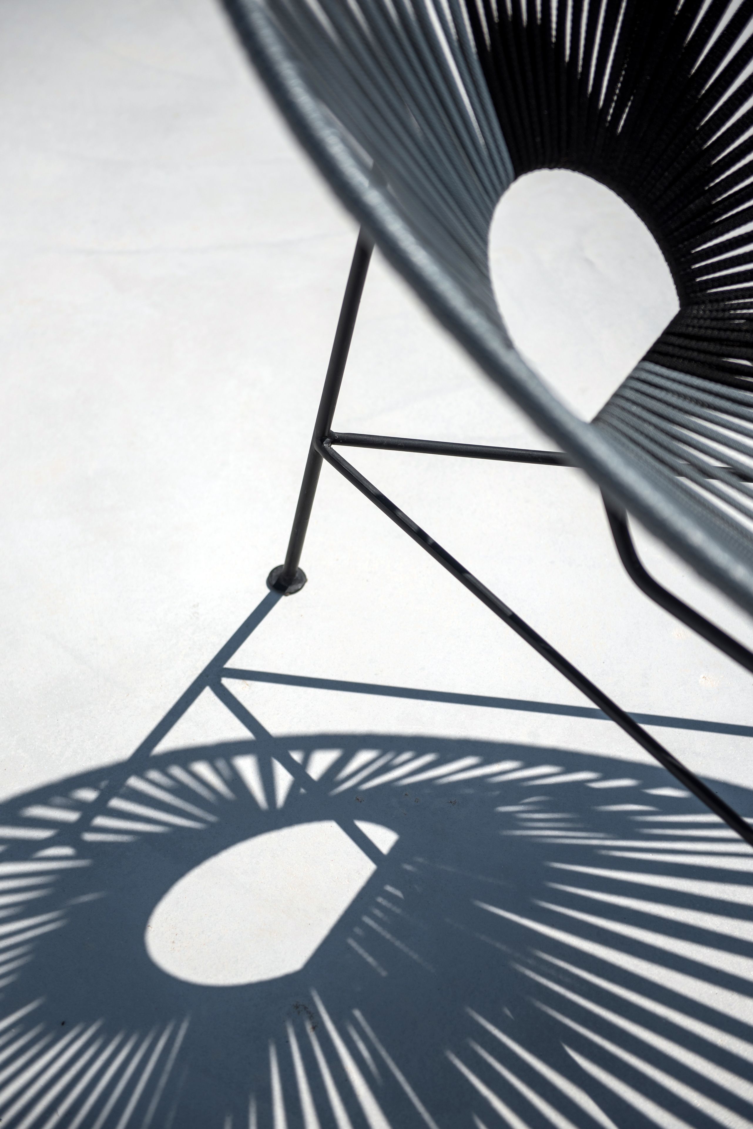 Een close-up van een metalen constructie met geometrische patronen en schaduwen.