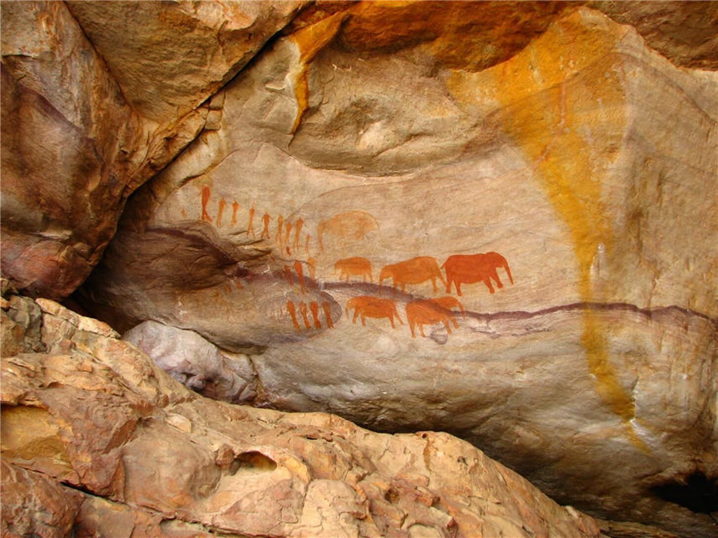 A cave with ancient rock paintings of animals and figures.