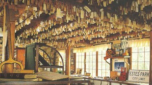 A room with a large collection of keys hanging from the ceiling, a table with dishes, and a sign indicating 'Key Room'. - Baldpate Inn (Estes Park)