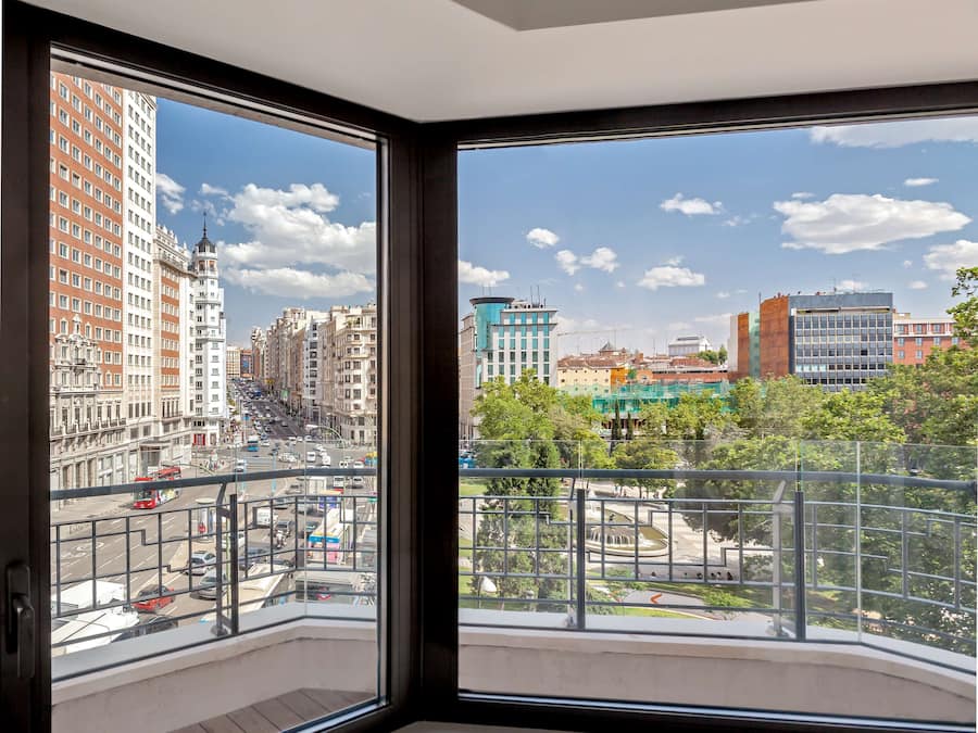 A high-rise building with a view of a cityscape through large windows.