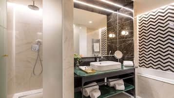 Un baño moderno con ducha, tocador con espejo y bañera.