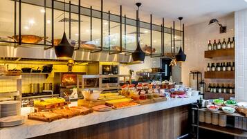 A buffet area with various food items and condiments.
