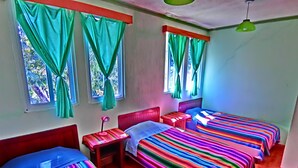 A room with three beds, a small table, and a lamp. - Hotel El Sol (Panajachel)
