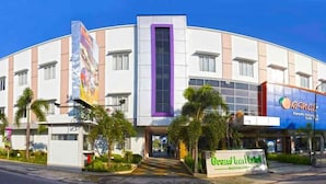 A hotel with a modern facade, multiple windows, and a prominent entrance. - Grand Inn Hotel Mataram (Mataram)