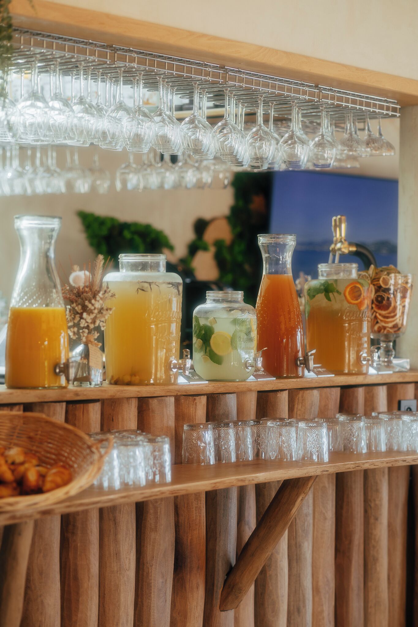 A bar area with various glassware and beverage dispensers.