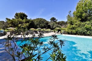 Seasonal outdoor pool, open 9:00 AM to 7:00 PM, pool umbrellas