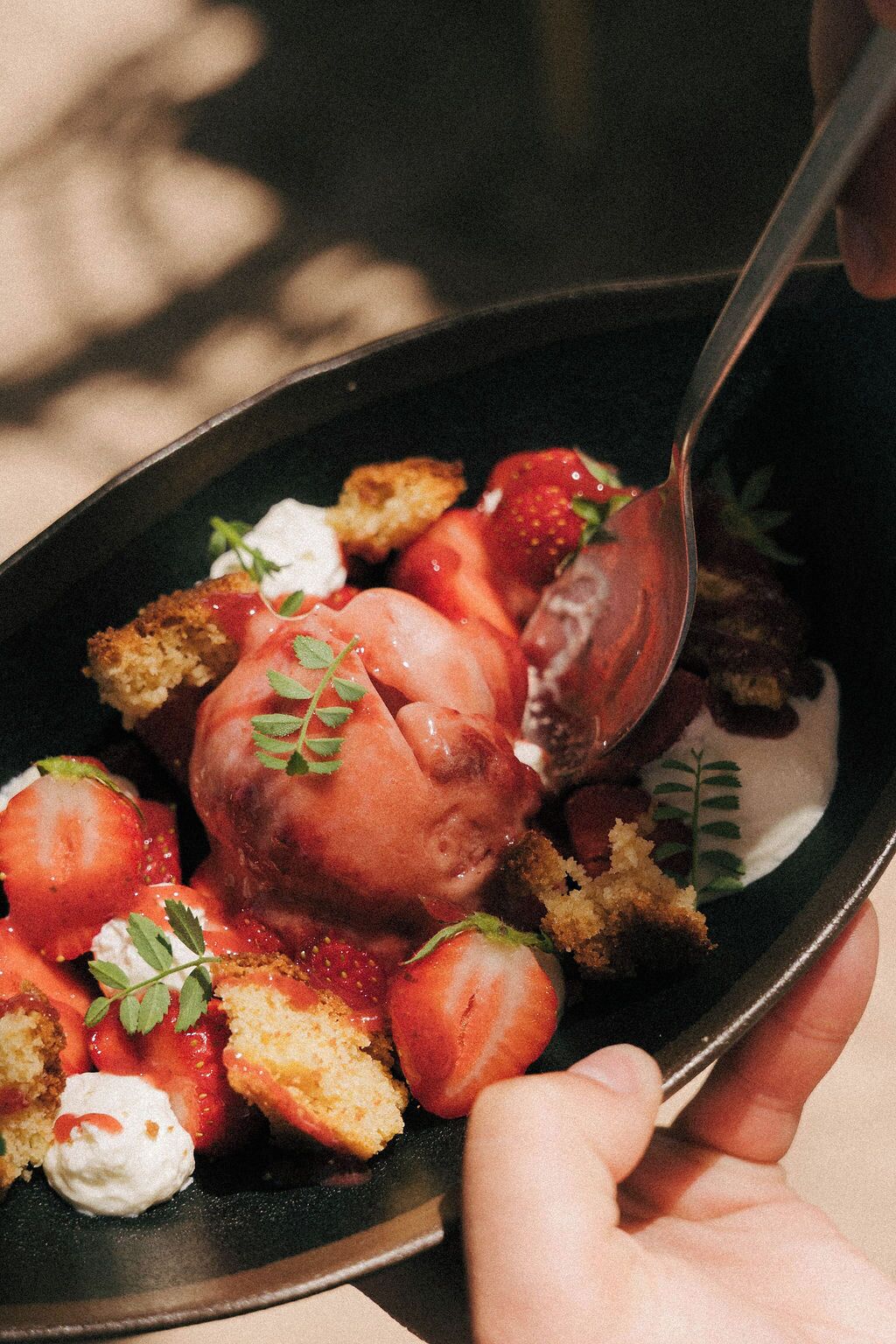 A dessert with strawberries and whipped cream on a plate.