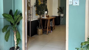 The entrance to a hotel named "Sleep at Phuket" with a teal exterior, a wooden archway, and a wall with a sleep-themed mural. - Sleep at Phuket (Phuket)