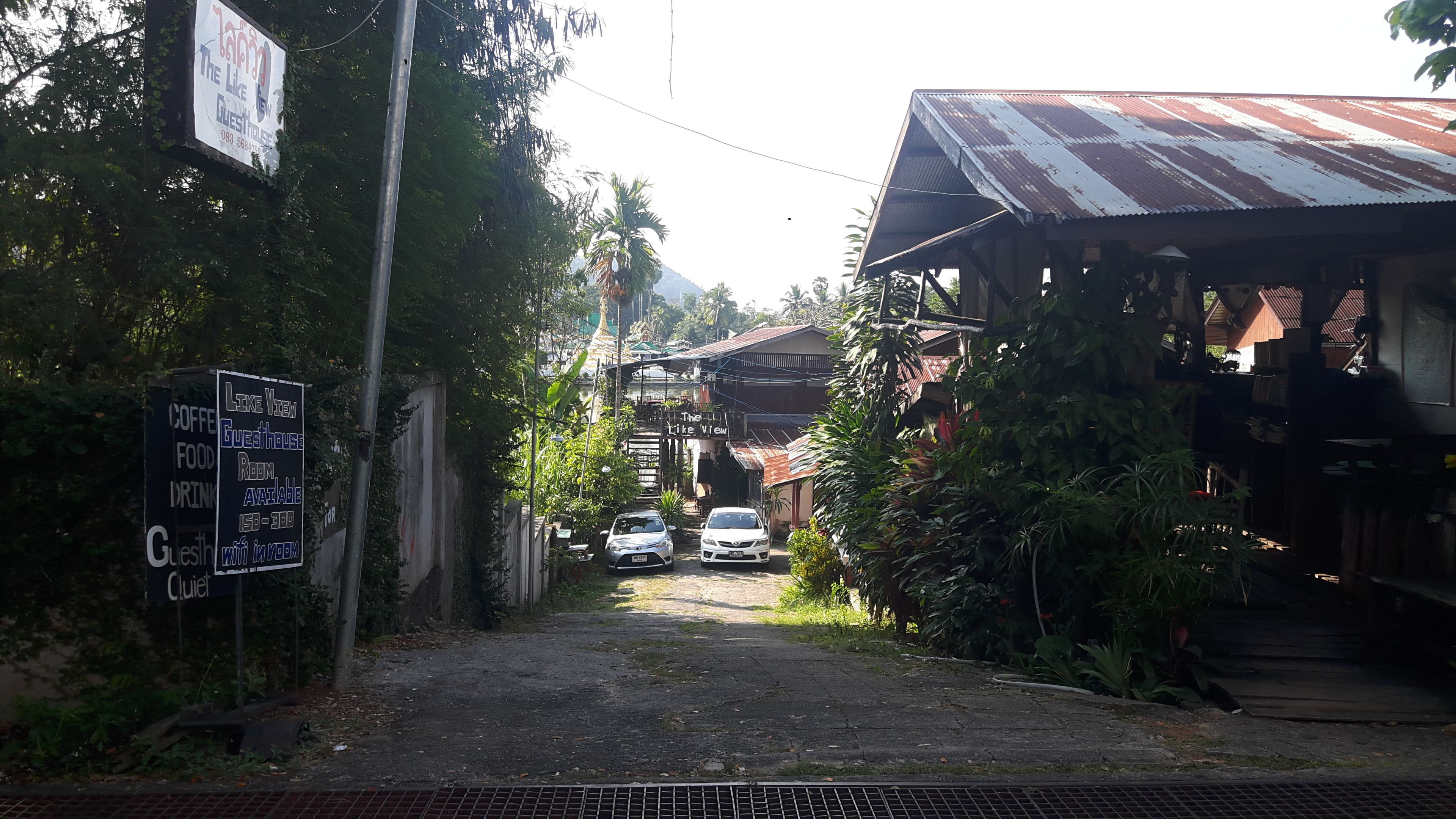 A narrow street leading to a building with a sign indicating 'The Like View Guesthouse'.