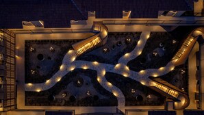A modern building with a unique spiral staircase design, multiple levels, and a courtyard with a patterned floor. - Eleonas Boutique Hotel & Spa (Rhodes)